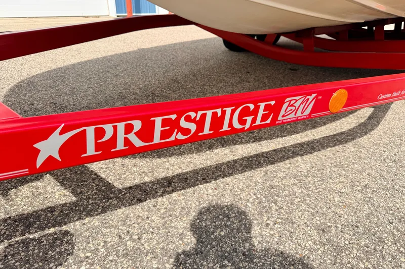Slide: The Image of Red Prestige boat trailer for 2006 Chaparral Sunesta 216 on asphalt surface. - 85