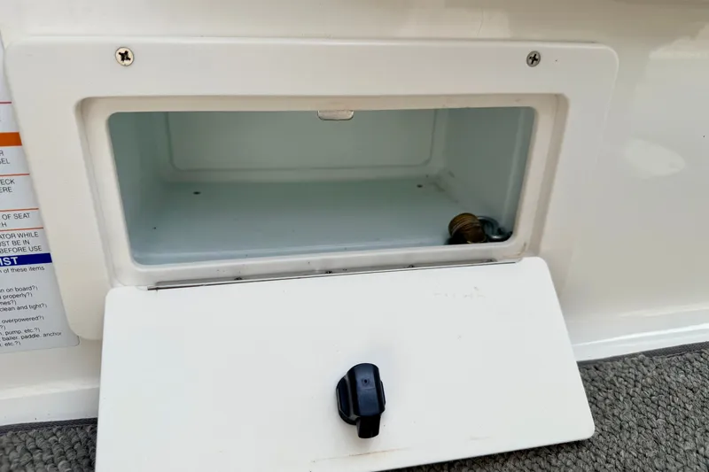 Slide: The Image of Open storage compartment on a 2006 Chaparral Sunesta 216 boat. - 55