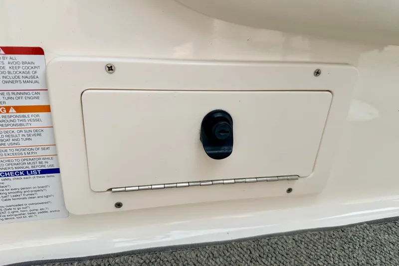 Slide: The Image of Access panel on a 2006 Chaparral Sunesta 216 boat with safety instructions. - 54