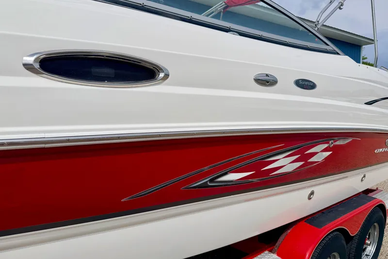 Slide: The Image of 2006 Chaparral Sunesta 216 boat with red and white exterior design. - 8
