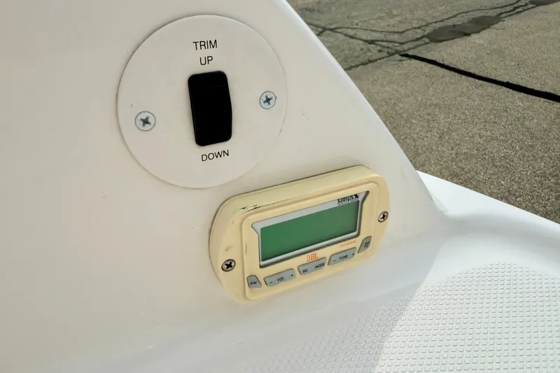 Slide: The Image of Control panel on a 2006 Chaparral Sunesta 216 boat with trim switch and marine radio. - 34