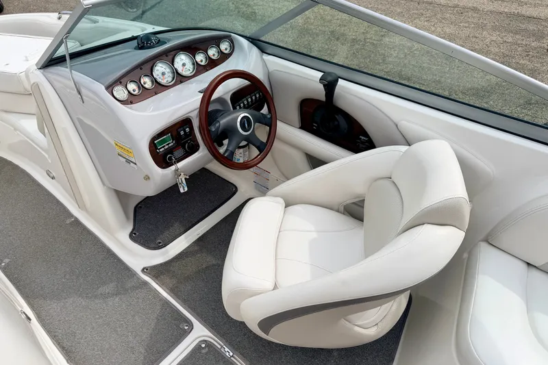 Slide: The Image of 2006 Chaparral Sunesta 216 boat interior with steering wheel and dashboard controls. - 48