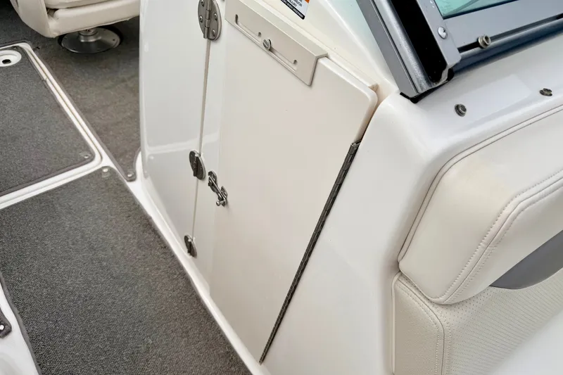 Slide: The Image of Interior view of a 2006 Chaparral Sunesta 216 boat, featuring seating and storage. - 61