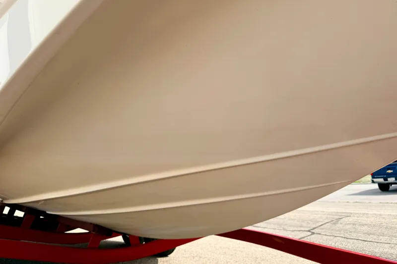 Slide: The Image of 2006 Chaparral Sunesta 216 boat hull on red trailer, close-up view. - 90