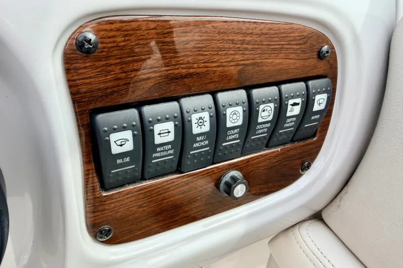 Slide: The Image of Control panel of a 2006 Chaparral Sunesta 216 boat with labeled switches. - 52