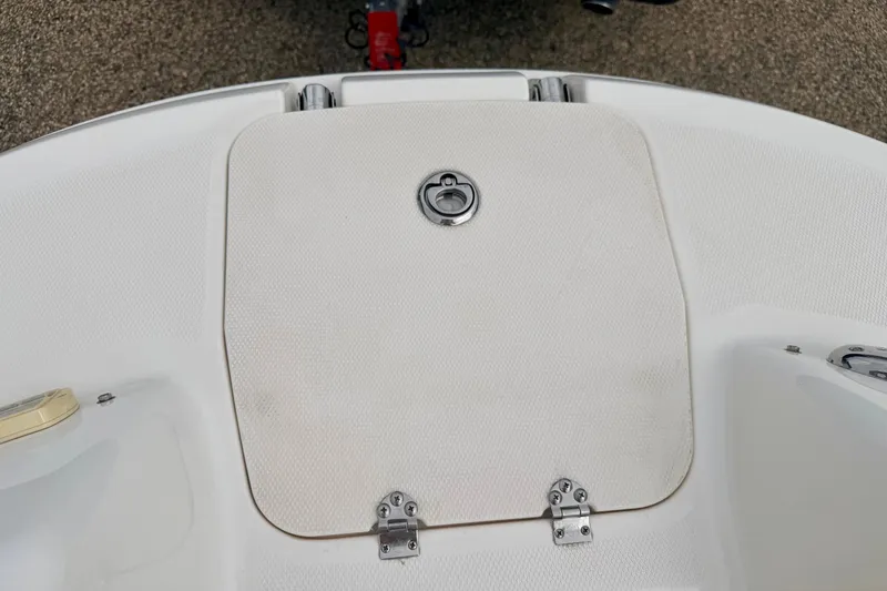 Slide: The Image of 2006 Chaparral Sunesta 216 boat hatch with metal latch and hinges on white deck. - 70