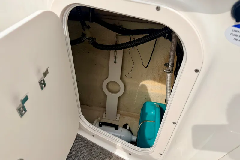 Slide: The Image of Storage compartment of a 2006 Chaparral Sunesta 216 boat, showing interior components. - 42
