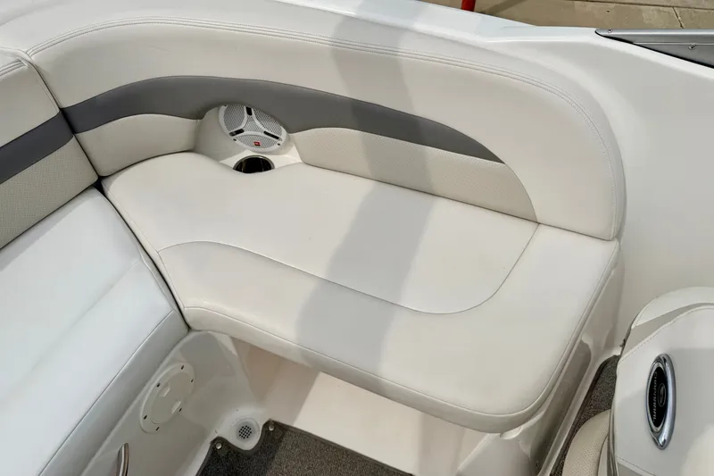 Slide: The Image of 2006 Chaparral Sunesta 216 boat interior with white cushioned seating and speaker. - 38