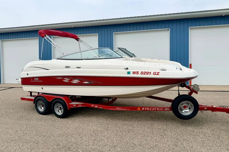 The Image of 2006 Chaparral Sunesta 216 boat on trailer, parked outside blue building. - 0