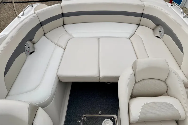 Slide: The Image of 2006 Chaparral Sunesta 216 boat interior with white and gray cushioned seating. - 58