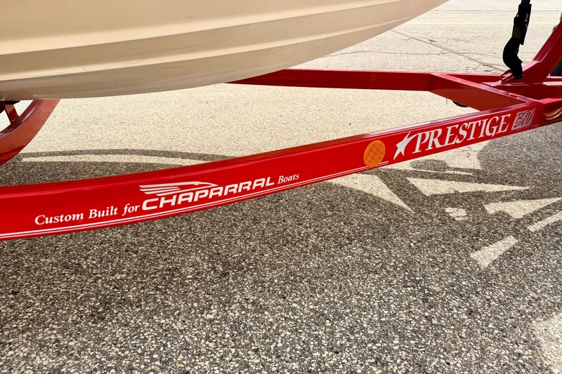 Slide: The Image of Red Prestige trailer custom-built for 2006 Chaparral Sunesta 216 boat on asphalt. - 89