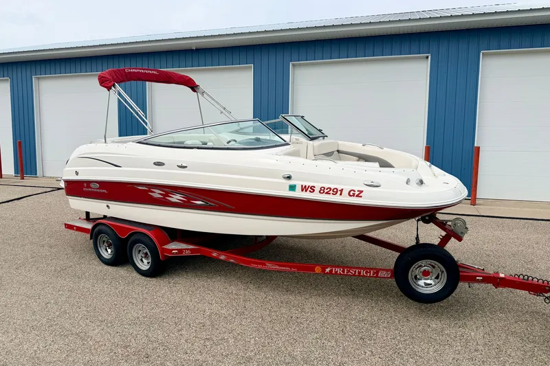 Slide: The Image of 2006 Chaparral Sunesta 216 boat on trailer, parked near blue storage units. - 4