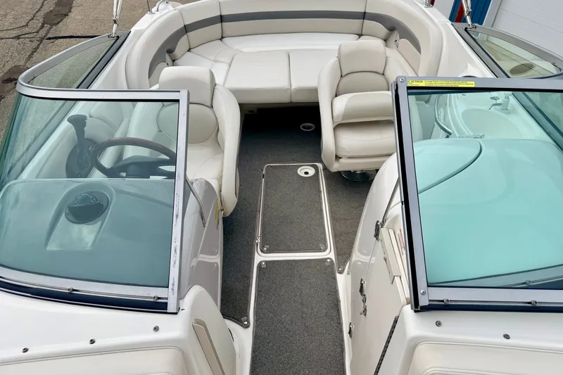 Slide: The Image of 2006 Chaparral Sunesta 216 boat interior with white seating and steering wheel. - 59