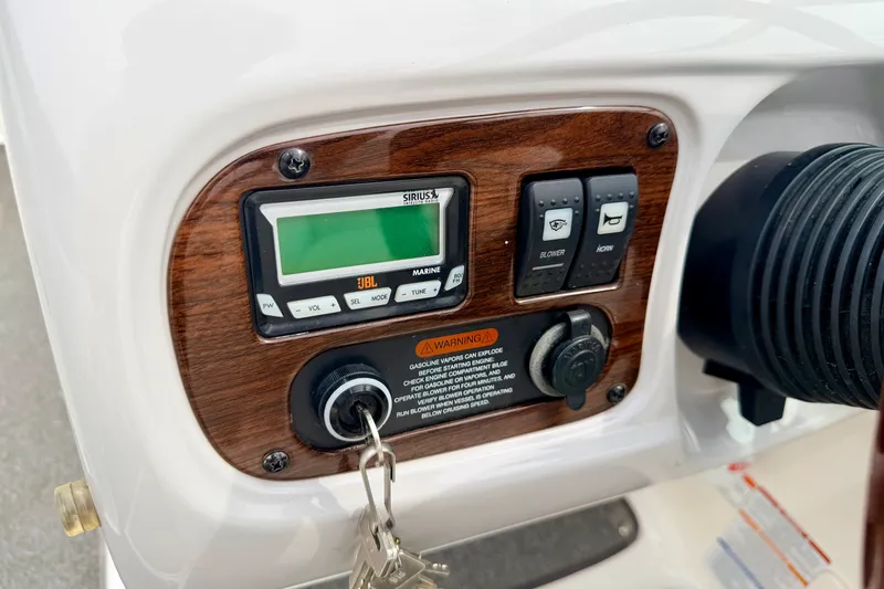 Slide: The Image of Control panel of a 2006 Chaparral Sunesta 216 boat with radio and switches. - 51
