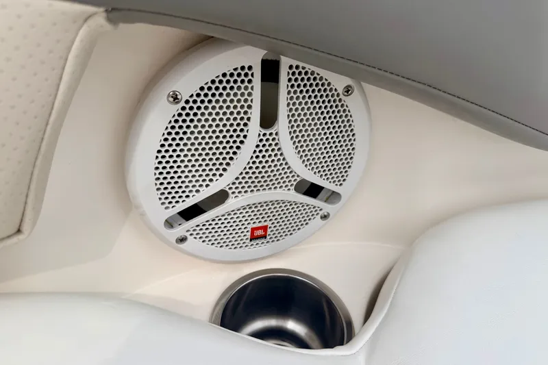 Slide: The Image of JBL speaker and cup holder in 2006 Chaparral Sunesta 216 boat interior. - 76