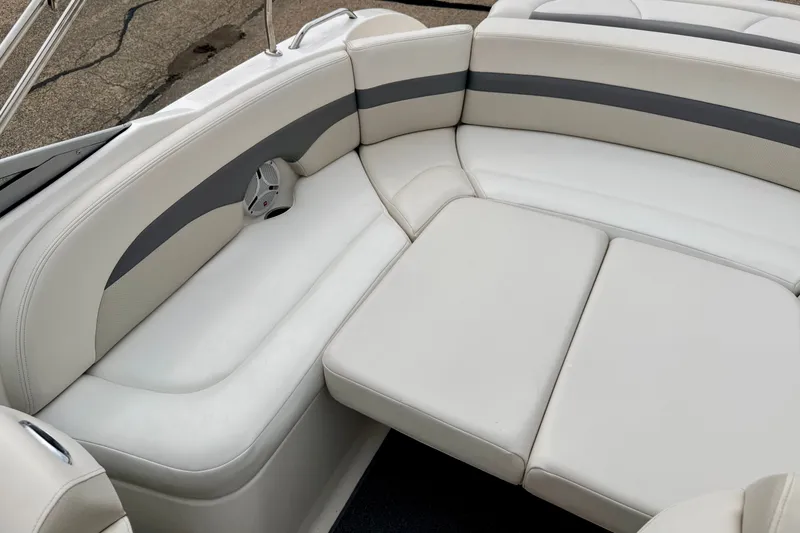 Slide: The Image of 2006 Chaparral Sunesta 216 boat interior with white cushioned seating and speaker. - 79