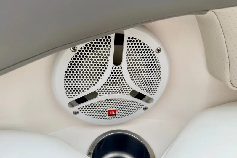 Slide: The Image of JBL speaker on 2006 Chaparral Sunesta 216 boat interior, featuring white upholstery. - 75