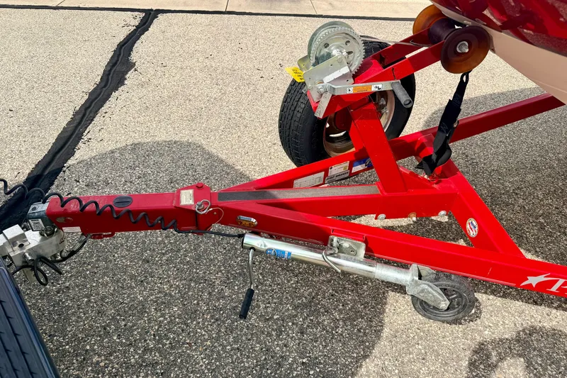 Slide: The Image of Red trailer hitch of a 2006 Chaparral Sunesta 216 boat on pavement. - 84
