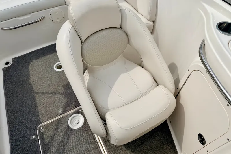Slide: The Image of 2006 Chaparral Sunesta 216 boat interior with plush white seating and carpeted flooring. - 40