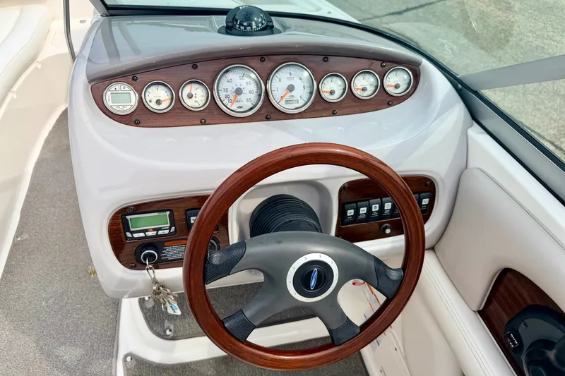 Slide: The Image of 2006 Chaparral Sunesta 216 dashboard with wood accents and steering wheel. - 49