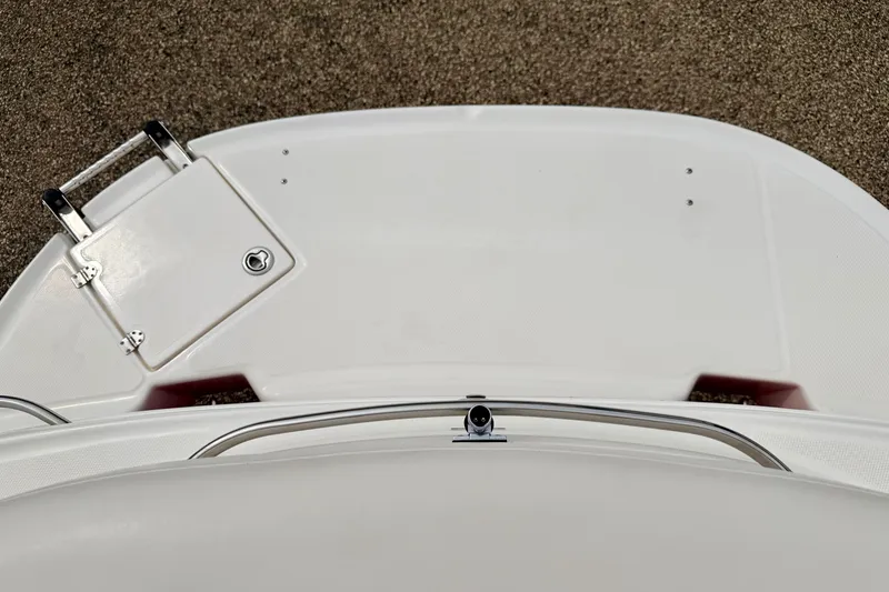 Slide: The Image of 2006 Chaparral Sunesta 216 boat deck with storage hatch and railing. - 26