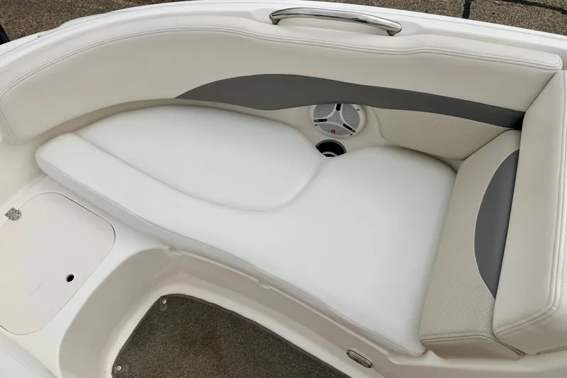 Slide: The Image of 2006 Chaparral Sunesta 216 boat interior with white cushioned seating and speaker. - 66