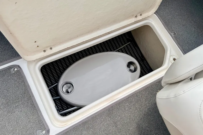 Slide: The Image of Storage compartment in a 2006 Chaparral Sunesta 216 boat with a removable lid. - 83