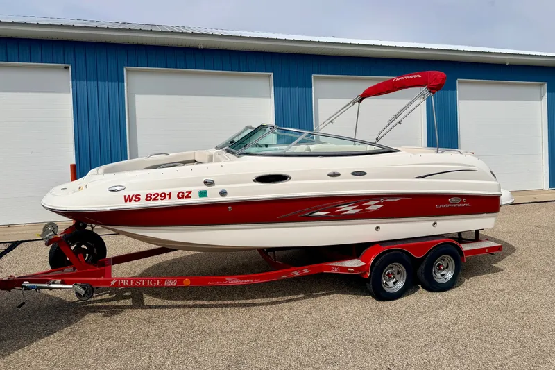 Slide: The Image of 2006 Chaparral Sunesta 216 boat on red trailer, parked near blue building. - 5