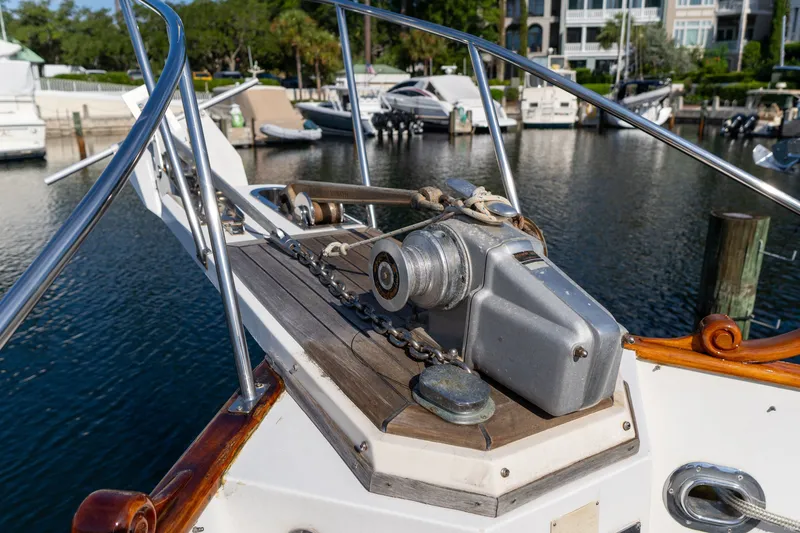 Slide: The Image of Bow of 1998 Grand Banks 46 Classic yacht with anchor winch in marina. - 90