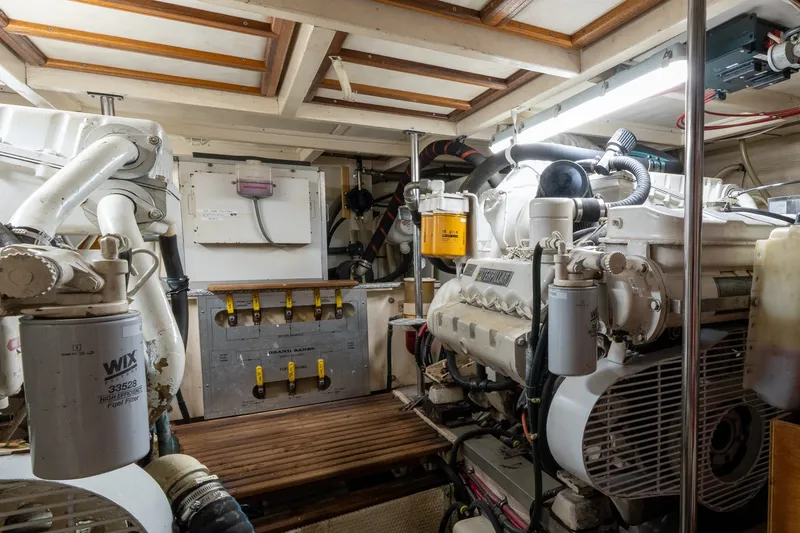 Slide: The Image of Engine room of a 1998 Grand Banks 46 Classic yacht, showcasing mechanical components. - 63