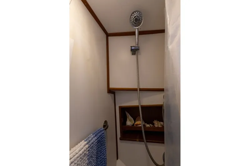 Slide: The Image of Shower area in 1998 Grand Banks 46 Classic yacht with wooden shelves and handheld showerhead. - 41