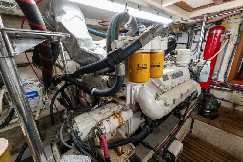 Slide: The Image of Engine room of a 1998 Grand Banks 46 Classic yacht, showcasing machinery and components. - 55