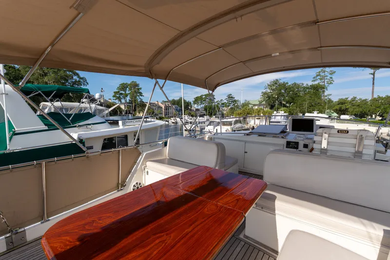 Slide: The Image of Flybridge of 1998 Grand Banks 46 Classic yacht with seating and navigation equipment. - 74