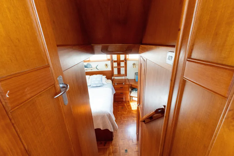 Slide: The Image of Interior of 1998 Grand Banks 46 Classic yacht, featuring a cozy wooden cabin. - 51
