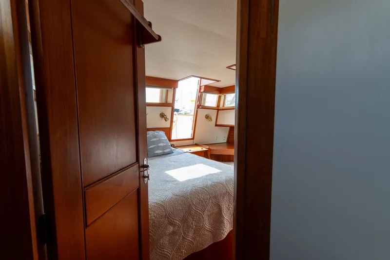 Slide: The Image of Cozy cabin interior of 1998 Grand Banks 46 Classic yacht with wooden finish. - 48