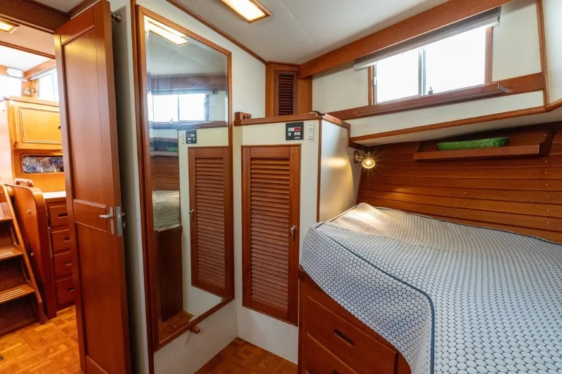 Slide: The Image of 1998 Grand Banks 46 Classic yacht interior with wooden cabinetry and cozy sleeping area. - 34