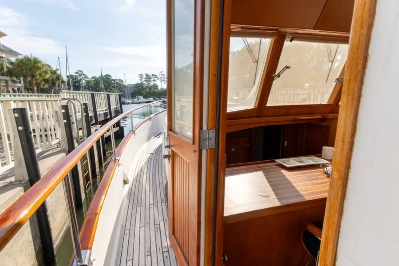 Slide: The Image of Side view of 1998 Grand Banks 46 Classic yacht with open cabin door. - 22