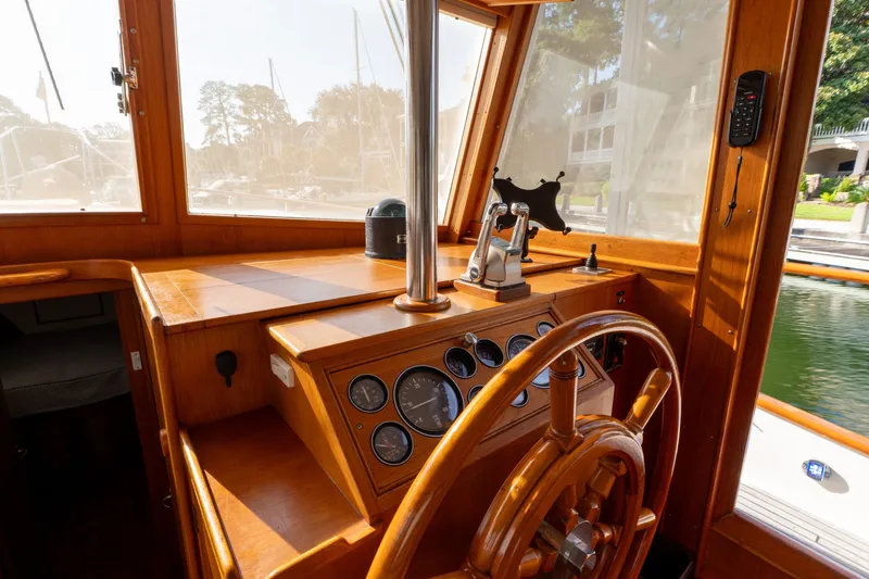 Slide: The Image of 1998 Grand Banks 46 Classic helm with wooden steering wheel and navigation instruments. - 25
