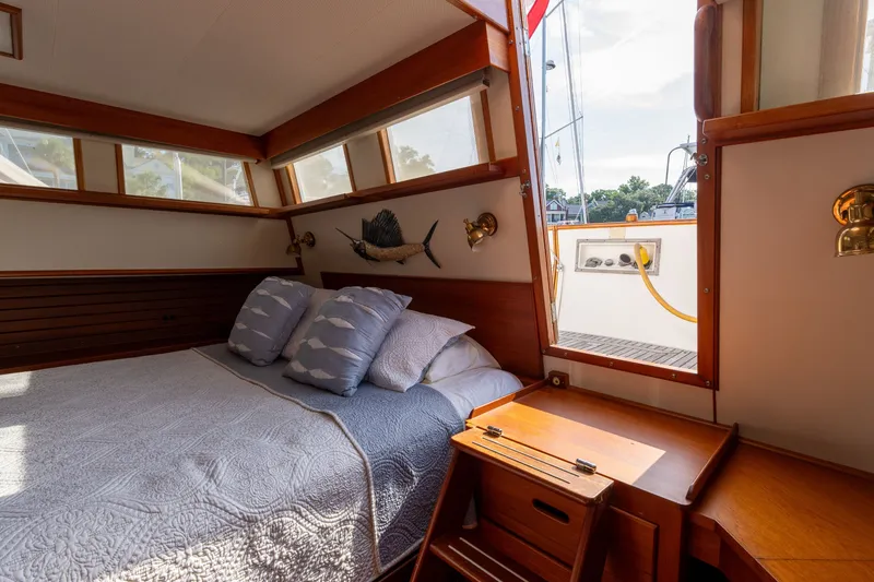 Slide: The Image of Cozy cabin interior of 1998 Grand Banks 46 Classic yacht with bed and wooden furnishings. - 43