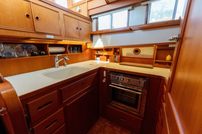 Slide: The Image of Cozy kitchen in 1998 Grand Banks 46 Classic yacht with wooden cabinetry and modern appliances. - 27