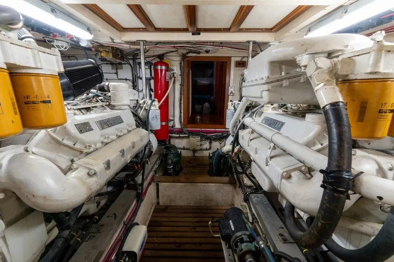 Slide: The Image of Engine room of a 1998 Grand Banks 46 Classic yacht, featuring dual Caterpillar engines. - 56