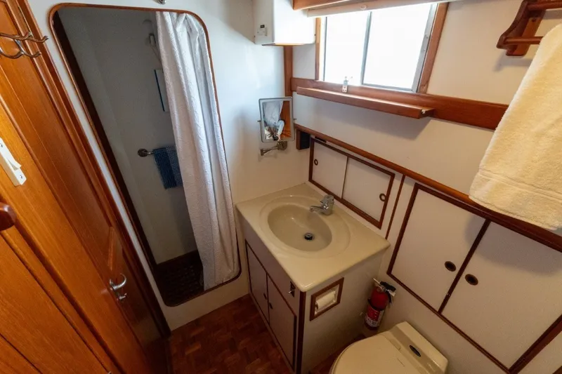 Slide: The Image of Bathroom interior of 1998 Grand Banks 46 Classic yacht, featuring sink, shower, and wooden accents. - 40