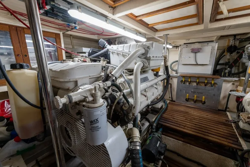 Slide: The Image of Engine room of a 1998 Grand Banks 46 Classic yacht, showcasing mechanical components. - 65