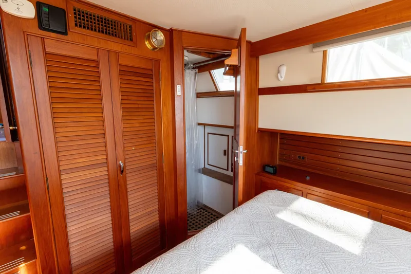 Slide: The Image of Interior of 1998 Grand Banks 46 Classic yacht with wooden cabinetry and cozy bedroom. - 47
