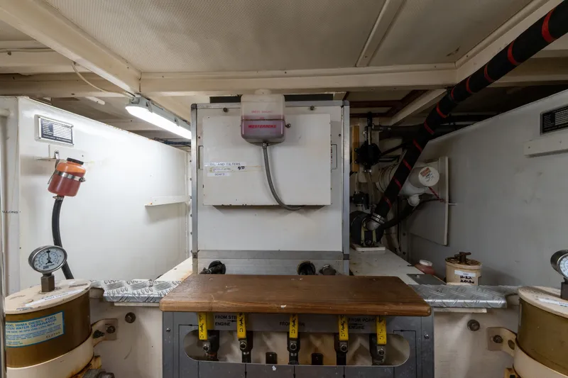 Slide: The Image of Engine room of 1998 Grand Banks 46 Classic yacht, featuring gauges and equipment. - 58