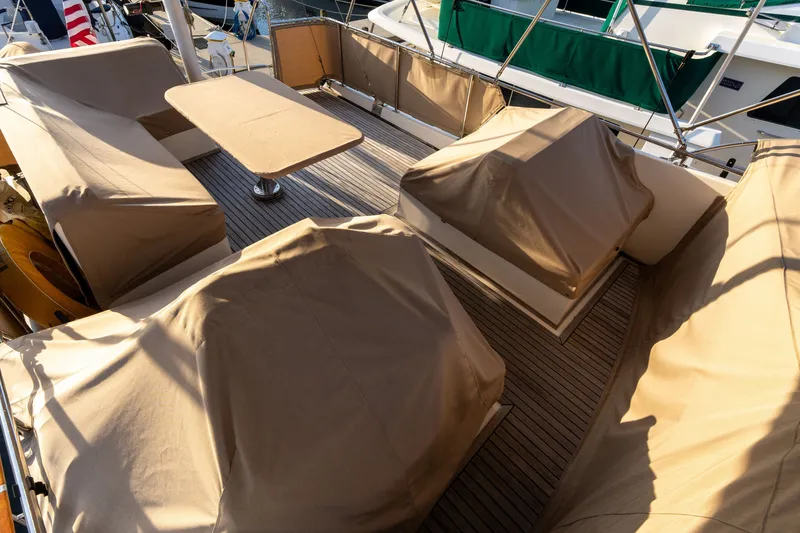 Slide: The Image of 1998 Grand Banks 46 Classic yacht deck with covered seating and table. - 69