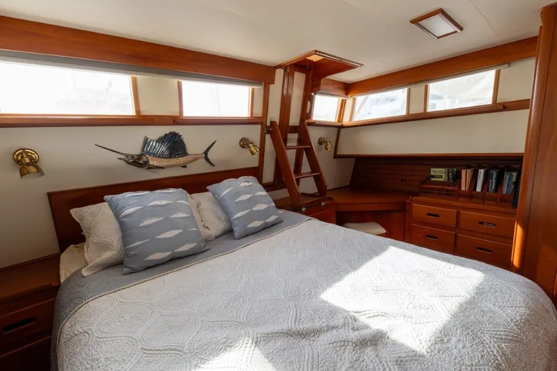 Slide: The Image of Luxurious cabin interior of 1998 Grand Banks 46 Classic yacht with cozy bed and wooden decor. - 52