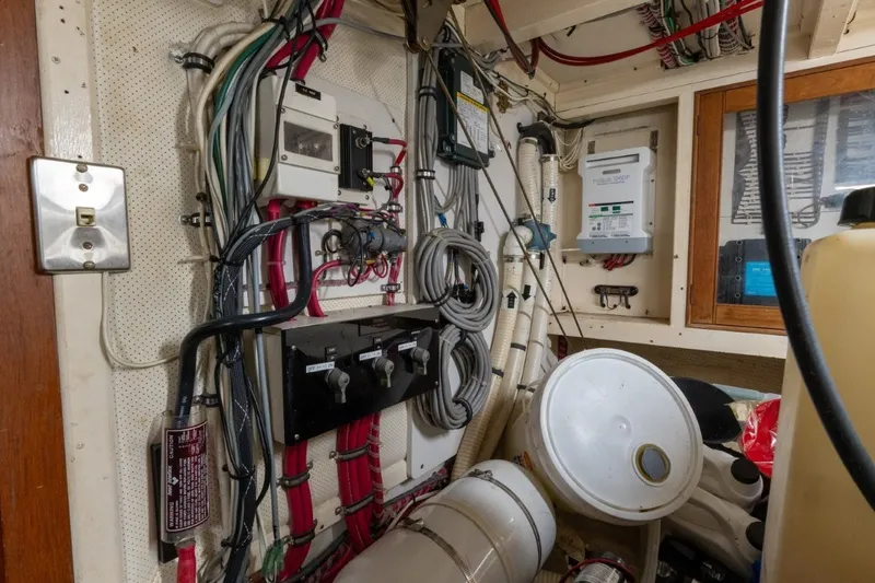Slide: The Image of Electrical wiring and control panel inside a 1998 Grand Banks 46 Classic yacht. - 64
