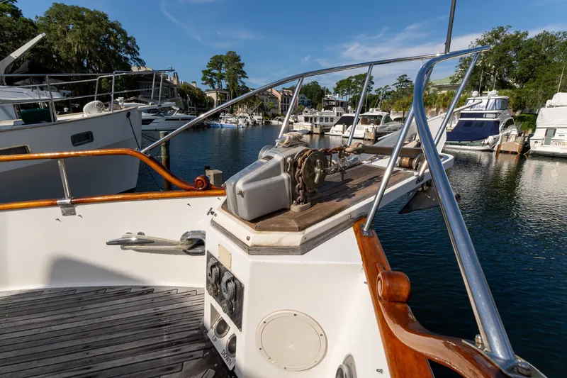 Slide: The Image of 1998 Grand Banks 46 Classic yacht docked in a marina, showcasing deck and railing. - 91