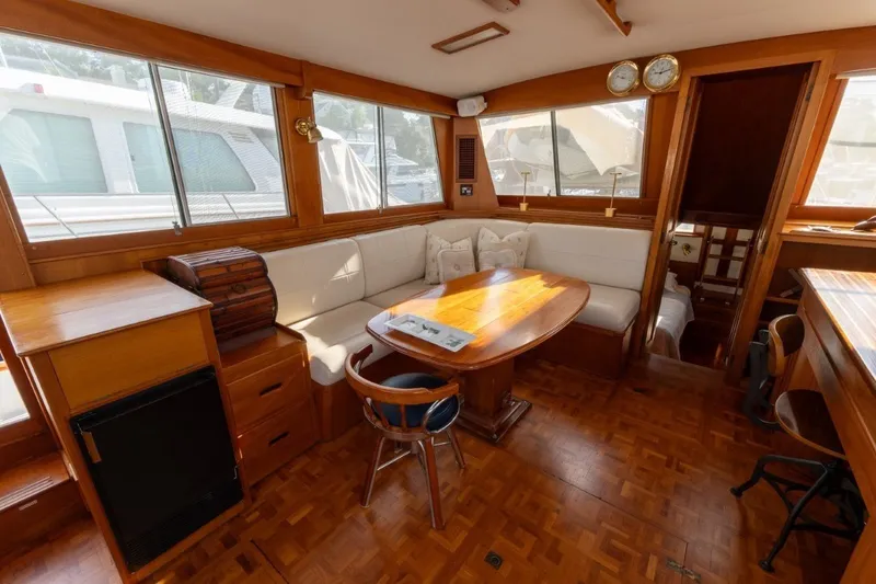 Slide: The Image of Interior of a 1998 Grand Banks 46 Classic yacht with wooden furnishings and cozy seating. - 17